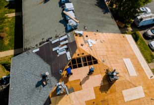 contractors on roof, installing asphalt shingles