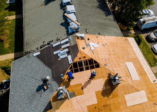 contractors on roof, installing asphalt shingles