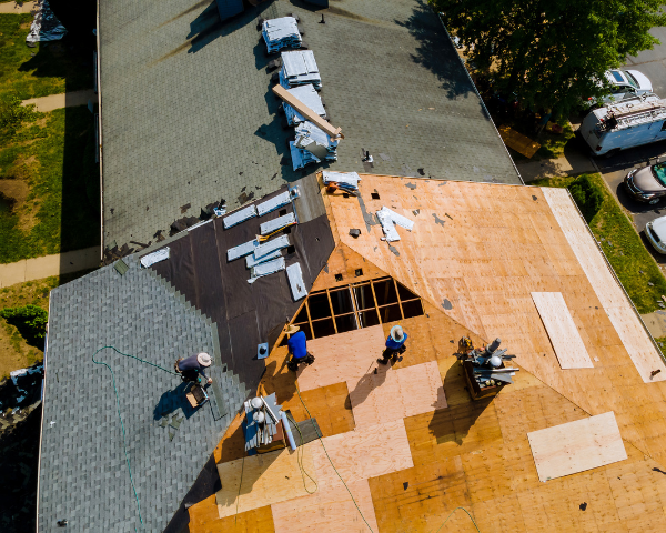 contractors on roof, installing asphalt shingles